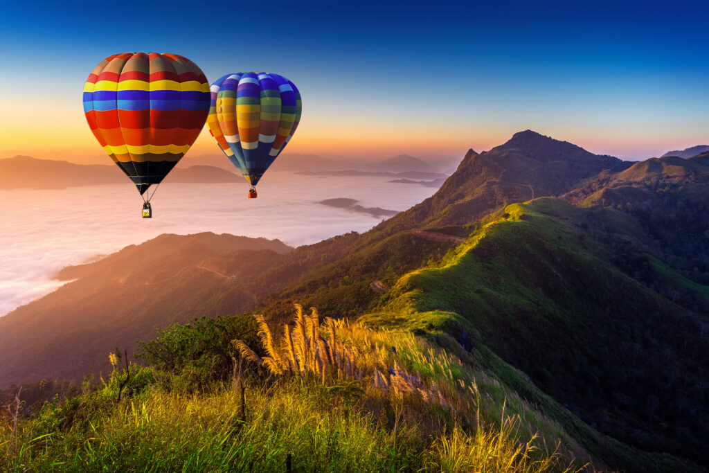 Landscape Of Morning Fog And Mountains With Hot Air Balloons At